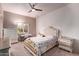 Bedroom with ornate bed frame, dresser, and ceiling fan at 9840 N 111Th Pl, Scottsdale, AZ 85259