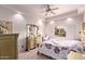 Bedroom with a floral bedspread, dresser, and ceiling fan at 9840 N 111Th Pl, Scottsdale, AZ 85259