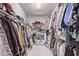Large walk-in closet with clothing racks and shelves at 9840 N 111Th Pl, Scottsdale, AZ 85259