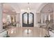 Grand entryway with high ceilings, chandelier, and ornate doors at 9840 N 111Th Pl, Scottsdale, AZ 85259