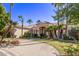 Luxury home with palm trees, circular driveway, and manicured lawn at 9840 N 111Th Pl, Scottsdale, AZ 85259