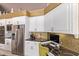 Modern kitchen with white cabinetry and granite countertops at 9840 N 111Th Pl, Scottsdale, AZ 85259