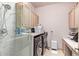 Laundry room with washer, dryer, and glass-enclosed shower at 9840 N 111Th Pl, Scottsdale, AZ 85259