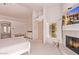 Main bedroom with fireplace, private access to the pool, and large TV at 9840 N 111Th Pl, Scottsdale, AZ 85259