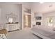 Main bedroom with fireplace, private access to the pool, and large TV at 9840 N 111Th Pl, Scottsdale, AZ 85259
