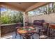Outdoor kitchen with seating for four and a built-in grill at 9840 N 111Th Pl, Scottsdale, AZ 85259