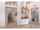 White wet bar with glass-front cabinets and mosaic tile backsplash at 9840 N 111Th Pl, Scottsdale, AZ 85259