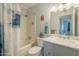 Clean bathroom with a shower/tub combo and updated vanity at 10412 W Audrey Dr, Sun City, AZ 85351