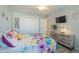 Bright bedroom with floral bedding, double closet, and wood-look floors at 10412 W Audrey Dr, Sun City, AZ 85351