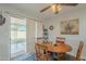 Dining area with wooden table and access to backyard at 10412 W Audrey Dr, Sun City, AZ 85351