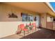 Covered patio with seating for two and potted plants at 10412 W Audrey Dr, Sun City, AZ 85351