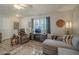 Living room featuring a comfortable sectional sofa and armchair at 10412 W Audrey Dr, Sun City, AZ 85351