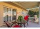 Covered patio with red chairs, table, and fire pit at 10412 W Audrey Dr, Sun City, AZ 85351