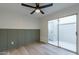 Bedroom with wood-look floors, ceiling fan, and access to a private patio at 10807 W Northern Ave # 133, Glendale, AZ 85307