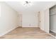 Bright and airy bedroom with wood-look flooring and mirrored closet doors at 1136 N 84Th Pl, Scottsdale, AZ 85257