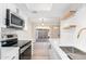 Modern kitchen features stainless steel appliances and white shaker cabinets at 1136 N 84Th Pl, Scottsdale, AZ 85257