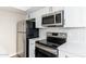 Modern kitchen with stainless steel appliances and white cabinetry at 1136 N 84Th Pl, Scottsdale, AZ 85257