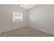 Bright bedroom with ceiling fan, window blinds, and neutral carpeting at 12391 W Tonto St, Avondale, AZ 85323