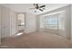 Main bedroom with bay window, ceiling fan, and access to the bathroom at 12391 W Tonto St, Avondale, AZ 85323