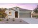 Single-story home with a two-car garage and desert landscaping at 12531 W Pkwy Ln, Avondale, AZ 85392