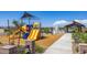 Community playground with modern play structures and shaded areas at 12548 W Parkway Ln, Avondale, AZ 85323