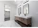 Double vanity bathroom with marble flooring and modern lighting at 16320 E Skinner Dr, Scottsdale, AZ 85262