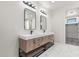 Double vanity bathroom with modern light fixtures and marble tile floors at 16348 E Skinner Dr, Scottsdale, AZ 85262