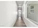 Long hallway with wood-look tile floors and bright lighting at 16348 E Skinner Dr, Scottsdale, AZ 85262