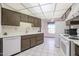 Kitchen with white appliances and dark brown cabinets at 17448 N Boswell Blvd, Sun City, AZ 85373