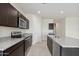 Bright kitchen with dark cabinetry, granite counters, and stainless steel appliances at 1764 W Stradling Ave, Apache Junction, AZ 85120