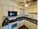 Kitchen with white cabinets, granite countertops, and modern appliances at 1831 E Kirkland Ln # B, Tempe, AZ 85281