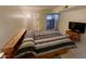 Main bedroom with king-size bed, wood nightstand, and access to patio at 1831 E Kirkland Ln # B, Tempe, AZ 85281