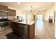 Open concept kitchen with island, stainless steel appliances and views to Gathering room at 19622 W Morning Glory St, Buckeye, AZ 85326