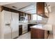 Galley kitchen with wood cabinets, ample counter space and appliances at 2007 W Flint St, Chandler, AZ 85224