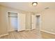 Bedroom with wood-look flooring, closet, and door at 2332 W Roy Rogers Rd, Phoenix, AZ 85085