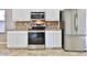 Stainless steel appliances and white cabinetry in the kitchen at 2332 W Roy Rogers Rd, Phoenix, AZ 85085