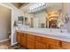 Double vanity bathroom with wood cabinets and a walk in shower at 24916 W Red Robin Dr, Wittmann, AZ 85361