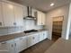 Modern kitchen with white cabinets, stainless steel appliances and pantry at 27018 N 168Th Ln, Surprise, AZ 85387