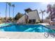 Inviting community pool with surrounding patio and palm trees at 30 E Brown Rd # 2053, Mesa, AZ 85201