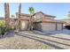 Two-story house with three car garage and desert landscaping at 3223 E Cedarwood Ln, Phoenix, AZ 85048