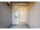 Light beige front door with glass panels and sidelights at 3223 E Cedarwood Ln, Phoenix, AZ 85048