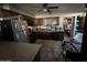 A cluttered kitchen with stainless steel appliances and dark wood cabinets at 350 N 88Th St, Mesa, AZ 85207