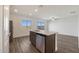 Open concept kitchen with island, stainless steel appliances, and vinyl plank flooring at 4055 N Ghost Hollow Way, Casa Grande, AZ 85122