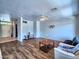 Living room with hardwood floors, neutral walls, and a cozy seating area at 44182 W Juniper Ave, Maricopa, AZ 85138