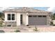 Single-story home with two-car garage and stone accents at 5420 W Las Palmaritas Dr, Glendale, AZ 85302