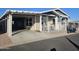 Single-wide manufactured home with carport and covered patio at 650 N Hawes Rd # 4101, Mesa, AZ 85207