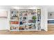 Floor-to-ceiling white bookshelves filled with various books and decor at 9015 N 86Th Pl, Scottsdale, AZ 85258