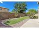 Landscaped backyard with grassy area and block wall at 992 E Sourwood Dr, Gilbert, AZ 85298