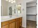 Double vanity bathroom with wood cabinets and a walk-in closet at 992 E Sourwood Dr, Gilbert, AZ 85298