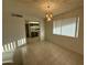 Dining room with tile floors and chandelier, open to kitchen at 10102 W Gulf Hills Dr, Sun City, AZ 85351